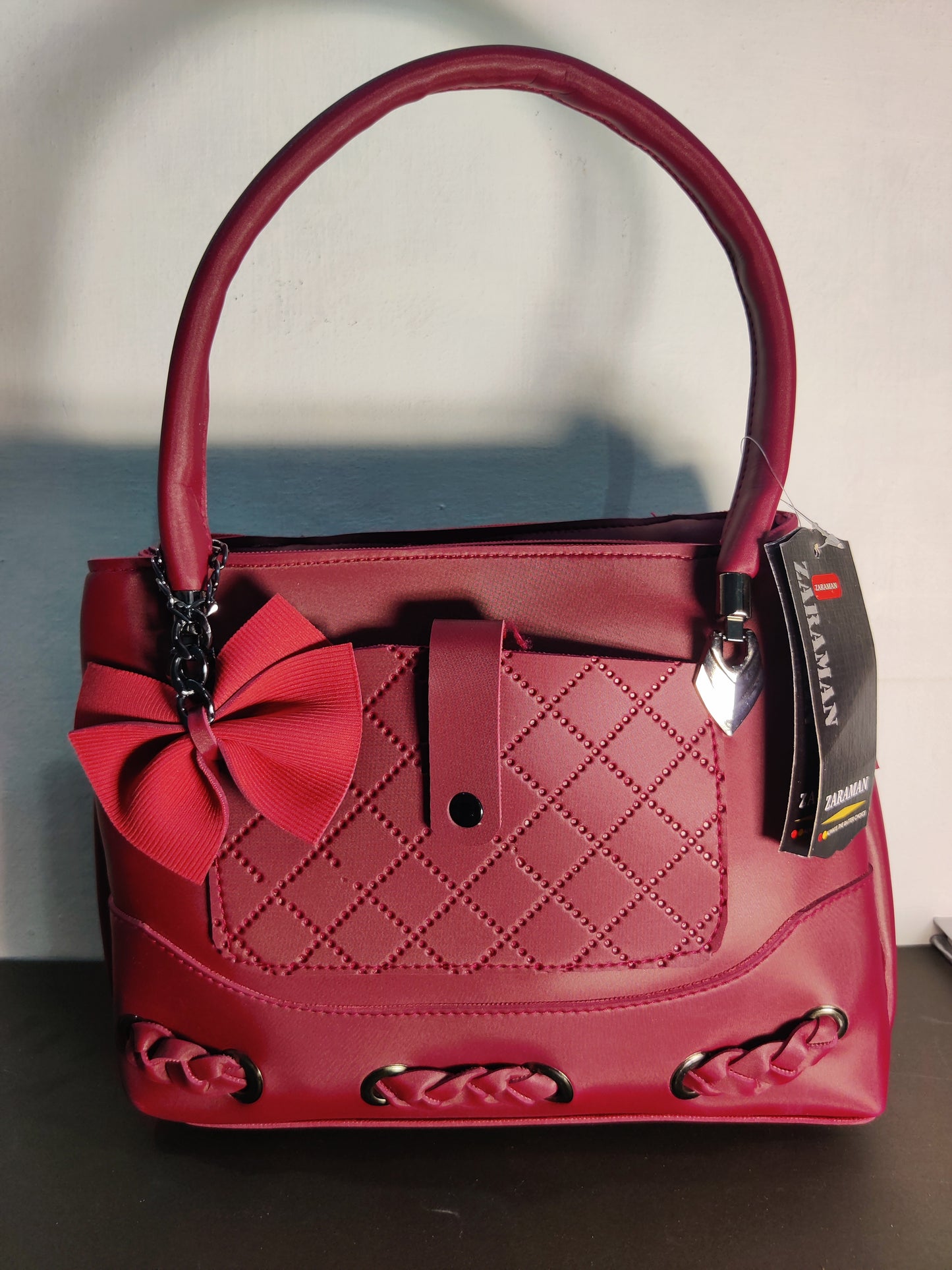 Zaraman Maroon Handbag is a Stylish, Top-handle Bag